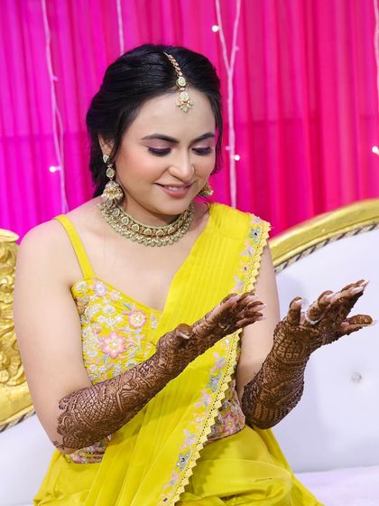 The bride admiring her henna, a classic and beautiful moment.