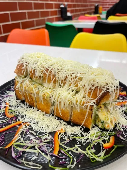 Another angle of the massive Italian Sandwich, showcasing the layers of filling and cheese.