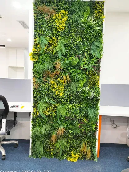 A full view of the freestanding artificial green wall panel before final placement in an office. This shows the density and quality of the foliage we use for our corporate projects.