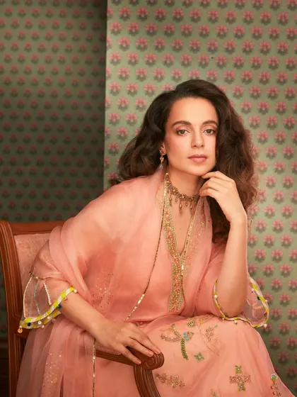 Kangana Ranaut looks absolutely elegant in this peach salwar suit from Raji Ramniq. The delicate embroidery and organza dupatta, paired with a traditional choker, create a look of timeless grace.