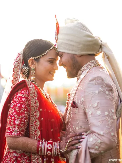 A beautiful, sun-kissed moment between the bride and groom. The natural light and genuine smiles make this a heartwarming and authentic wedding portrait.