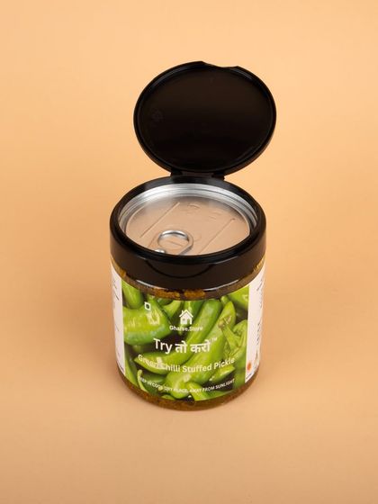 A jar of Green Chilli Stuffed Pickle with the lid open, showing the fresh-sealed top.