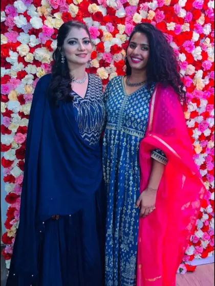 Posing with a friend at a wedding function. My blue and gold printed Anarkali is a classic choice for wedding guest attire, offering both elegance and comfort for a long evening.