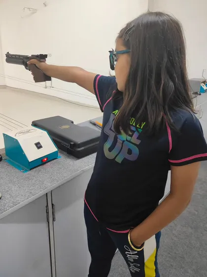 A young shooter takes aim during our summer camp. These camps are a fantastic way for kids to learn a new sport, develop concentration, and have fun during their vacation.