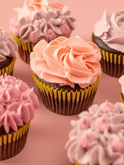 A beautiful assortment of my Belgian chocolate cupcakes topped with irresistible vanilla buttercream frosting in various shades of pink. Perfect for brightening up any day.