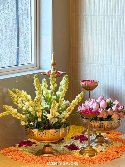 The beauty of an event is often in its smallest corners. This traditional decor setup, with brass urlis, fresh tuberoses, and lotus buds, shows my passion for detail. I ensure every element, no matter how small, contributes to a warm and harmonious atmosphere.