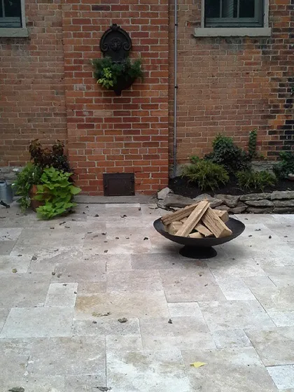 This is another view of a patio I installed. The large, square pavers give it a modern feel that contrasts nicely with the classic brick wall.