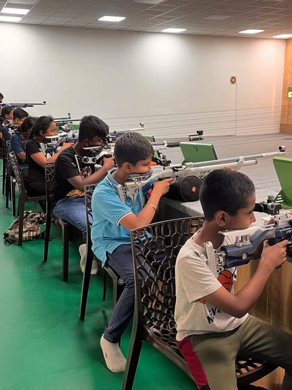 Shooters practicing from a seated position, a valuable technique that offers a great balance between stability and adaptability.