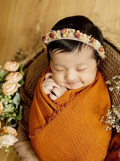 That sleepy newborn smile is just priceless. For my posed newborn sessions, I bring soft wraps, beautiful props, and a lot of patience to capture these peaceful, angelic portraits right in your home.