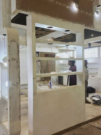 Another angle of booth construction, showing the framework and interior elements being put together.