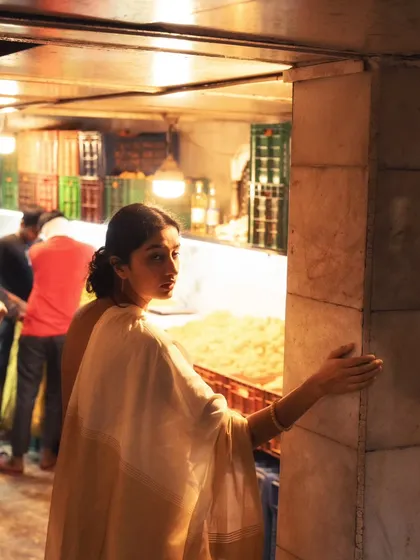 A candid moment of exploration in the market. The background shows the real, unposed environment which makes the portrait feel more alive.