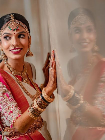 Another beautiful reflection shot, this time capturing a profile view. You can see the details of the eye makeup, the elegant hair, and the traditional nose ring.