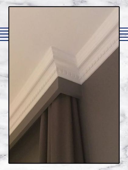 A close-up of our intricate cornice and ceiling moulding. This level of detail is a hallmark of our classical design style and adds a touch of grandeur to any room.