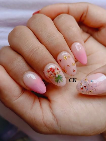 A delicate design using real dried flowers encapsulated in the nail, paired with a soft pink ombre.