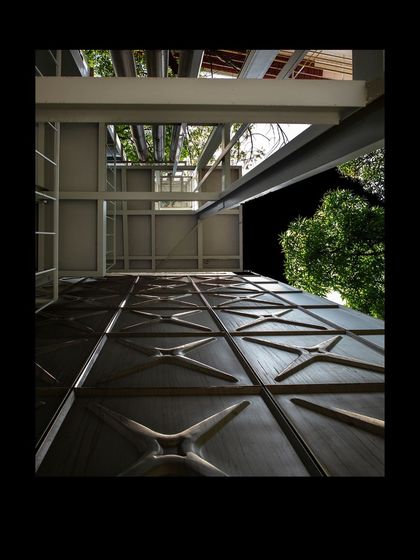 A low-angle shot of the MAP museum's facade, emphasizing its texture and scale against the night sky.