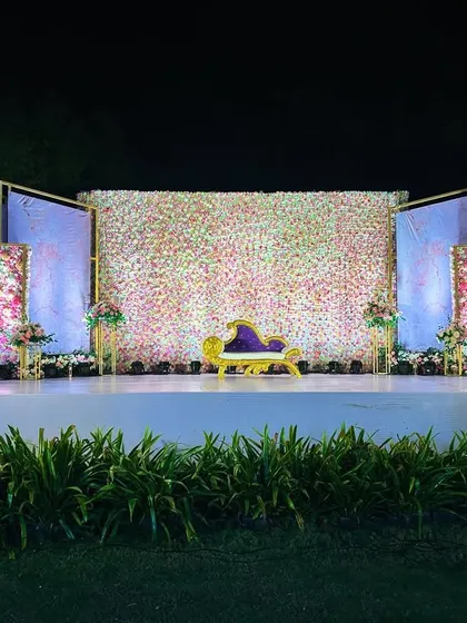 A final look at this beautiful reception stage, set against a lush green lawn, ready to welcome the happy couple.