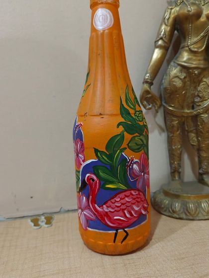 A participant's finished piece from the 'Jungle Jharoka' workshop, beautifully displayed next to a statue. Art truly enhances any space.