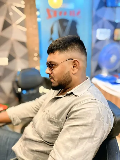 This angle highlights the clean fade and the shape of the haircut. It's a popular and versatile style that always looks good.