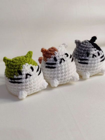 My collection of chubby cat keychains. These little guys come with different colored patches on their heads, including yellow, green, pink, blue, and grey.