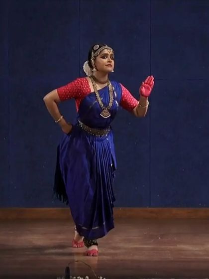 A full-body shot showing the classic 'Araimandi' posture, which requires immense stability and is fundamental to Bharatanatyam. This pose is from a slower, more meditative section of a traditional piece.