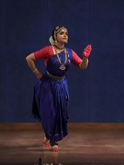 A full-body shot showing the classic 'Araimandi' posture, which requires immense stability and is fundamental to Bharatanatyam. This pose is from a slower, more meditative section of a traditional piece.
