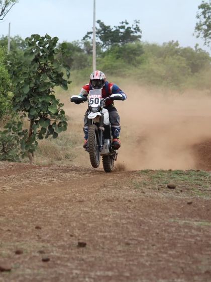Our coach Pradeep demonstrates his off-road prowess, getting air on a dirt bike during a rally. His experience spans multiple formats, from circuit racing to the rugged stages of rally championships.