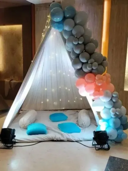 A simple and sweet tent decoration. We used a sheer canopy with fairy lights and a multi-colored balloon garland to create a cozy and magical little hideaway for a birthday surprise.