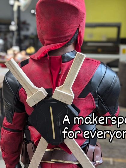 A makerspace for everyone, even superheroes. A member dressed as Deadpool shows off their custom-made wooden swords and 3D printed back-holster, proving that you can make absolutely anything you can imagine here.