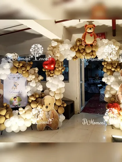The entrance to a teddy bear-themed party, featuring a circular balloon arch in brown and white, and several adorable teddy bear cutouts to welcome guests.