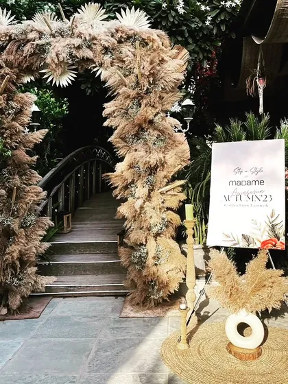 A beautiful boho-chic entrance arch made entirely of pampas grass and dried botanicals, created for a fashion event, showcasing our versatility in themed decor.