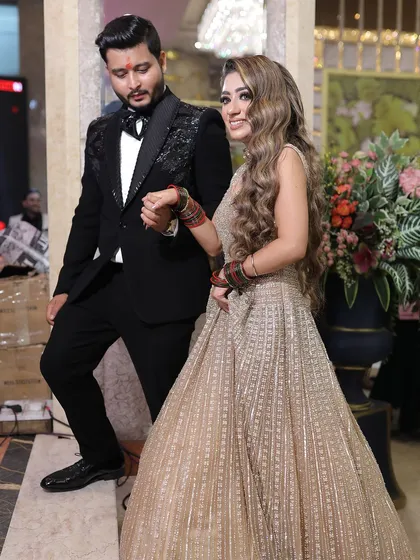 A candid moment of the couple walking hand-in-hand at their engagement party, capturing the natural flow of the event.