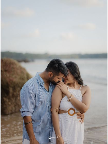 An intimate embrace on the shores of Goa, the soft light of dusk creating a perfectly romantic atmosphere.