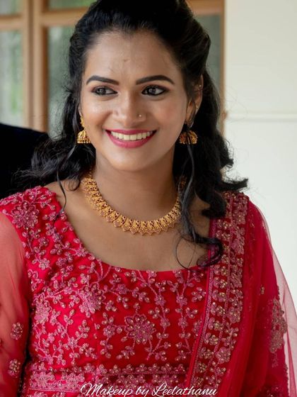 A close-up of a smiling bride-to-be at her Christian engagement. Her makeup is simple and elegant, with a focus on radiant skin and a bright smile.