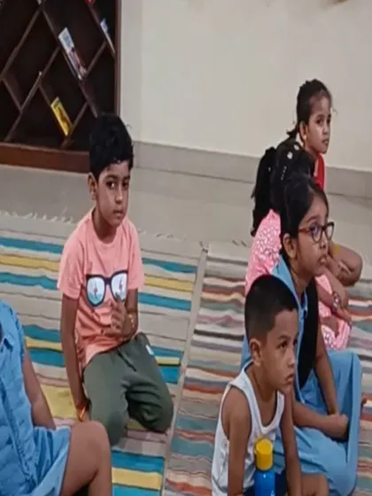 A close up of the children's faces shows their complete absorption in the story of the ant queen.