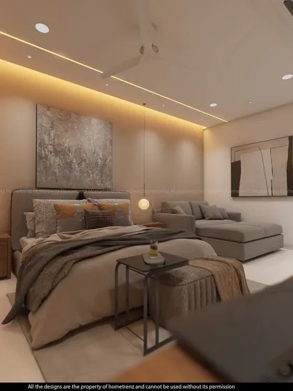 A view from the desk in the guest suite, showing the layered and comfortable bedding and the soft, ambient lighting.