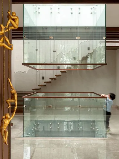 A sculptural staircase with golden figurines climbing the wall. This feature turns a functional element into a piece of art, adding a touch of whimsy and sparking curiosity as you move through the home.