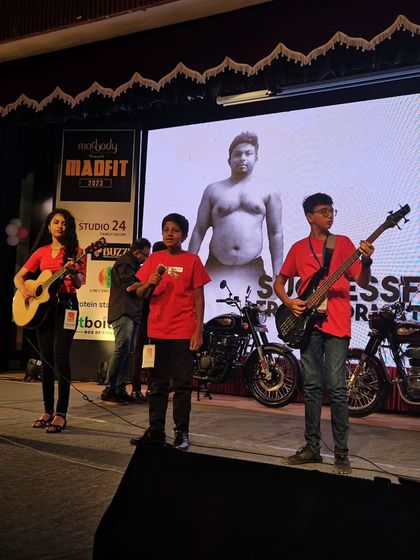 More action from the Madfit 2023 concert, with our students on vocals and bass guitar, performing in front of a large LED screen.