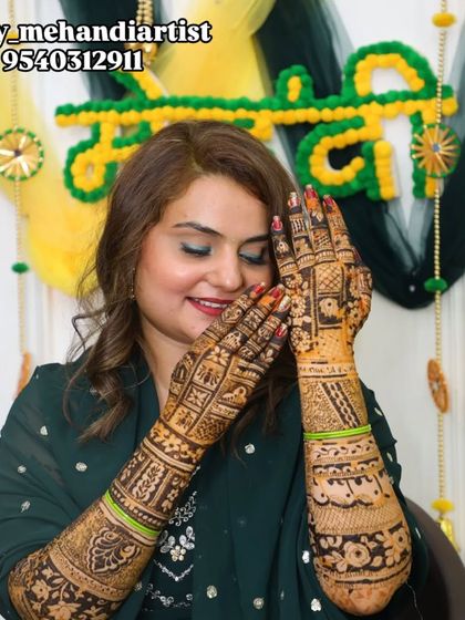 A playful and happy bride showing off her detailed mehndi. Her joy is infectious.