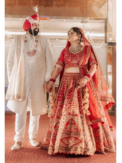 A joyful, candid shot of Ishita and Dipender, their smiles lighting up the frame as they hold hands, perfectly capturing their happiness.