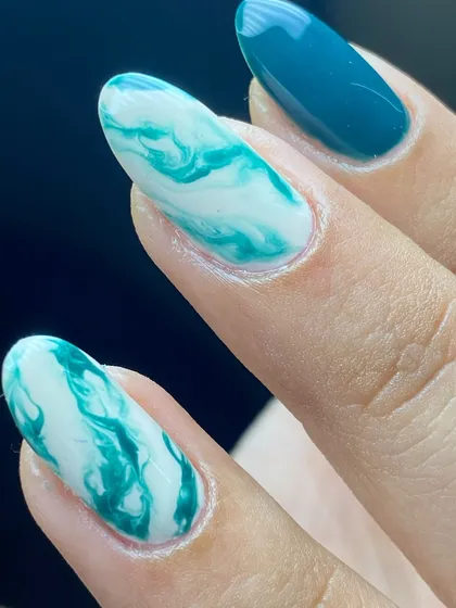 A classic and simple teal and white marble design that looks like ocean waves.