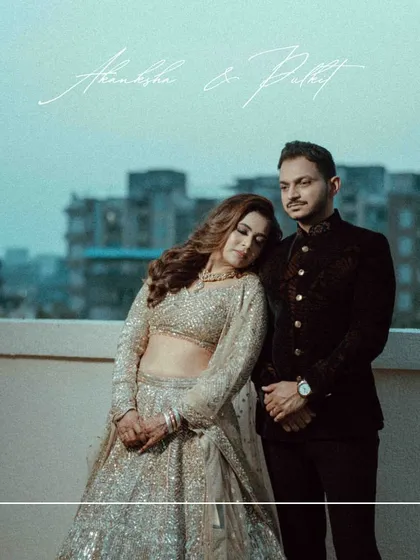 A moody and romantic rooftop portrait. The elegant lehenga and the city skyline at dusk create a sophisticated and modern pre-wedding look.