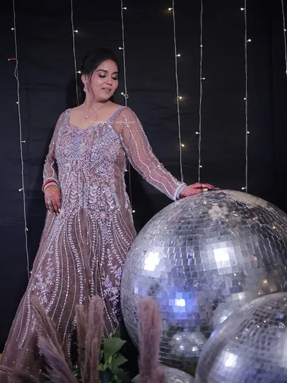 A full-length view of a stunning sangeet look. The makeup is designed to be glamorous and eye-catching, even from a distance, perfect for a grand celebration.