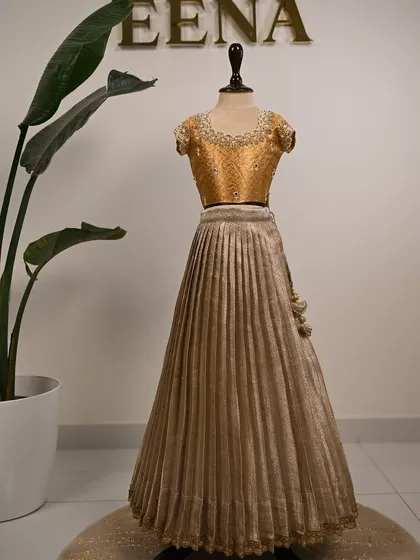 My super energetic baby client Smaya looks absolutely adorable in her customized tissue lehenga. I designed this golden outfit with a beautiful hand-embroidered blouse featuring pearl and stone work around the neckline.