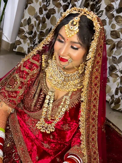 A beautiful downward glance of the bride, showcasing the detailed eye makeup and the traditional nose ring (nath), which are key elements of this heritage look.