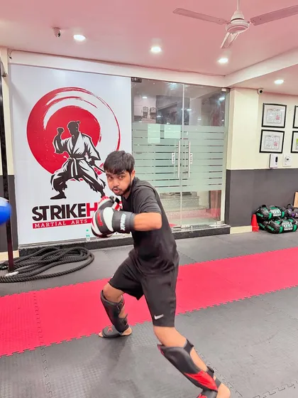 A student demonstrates a strong defensive stance while preparing to strike. Proper form is the foundation of everything we teach, ensuring both safety and effectiveness.