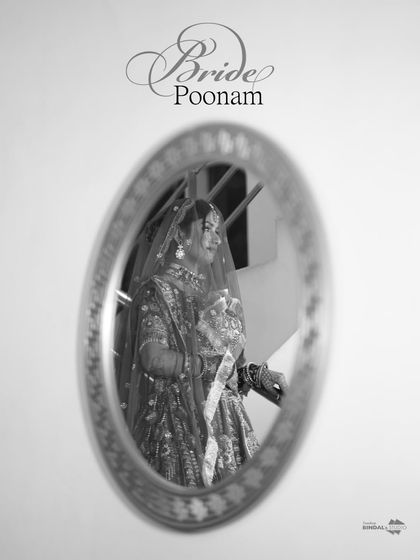 An artistic black and white shot of the bride's reflection in a mirror. The motion blur adds a dreamy, ethereal quality to this creative portrait.