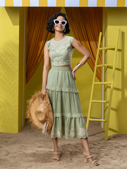 A cheerful, full-body shot for Boho-Chic, highlighting a tiered skirt and accessories as part of their resort wear campaign.