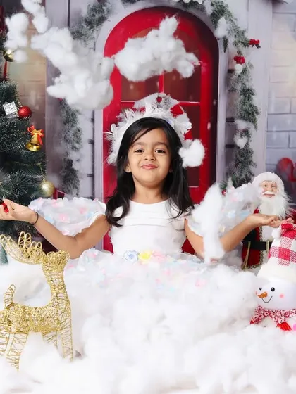 Creating a magical snow flurry in the studio for this Christmas portrait session.