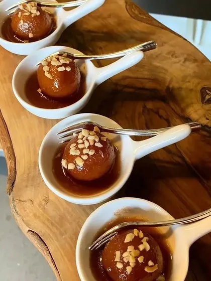 We serve our classic Gulab Jamuns in individual portions, garnished with chopped nuts. This timeless Indian sweet is a staple on our catering menus for all occasions.