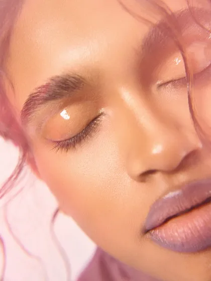 A dreamy, soft-focus beauty shot using a split diopter lens. This technique creates a gentle blur, focusing attention on the glossy eyelid and serene expression.